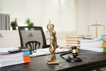 A lawyer's desk in the office is filled with legal documents.The lawyer provides consultations on...