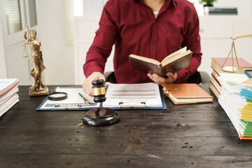 A male lawyer is working at his desk on an online judicial review, focusing on justice, fairness,...