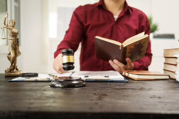 A male lawyer is working at his desk on an online judicial review, focusing on justice, fairness, and legal compliance.He reviews cases, contracts, and legal matters based on general law principles