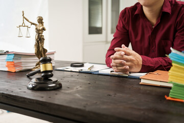 A male lawyer is working at his desk on an online judicial review, focusing on justice, fairness, and legal compliance.He reviews cases, contracts, and legal matters based on general law principles