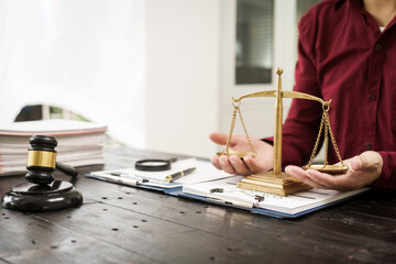 A male lawyer is working at his desk on an online judicial review, focusing on justice, fairness, and legal compliance.He reviews cases, contracts, and legal matters based on general law principles