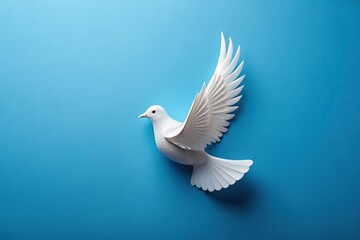 Obraz premium paper white dove with green leaves on a blue background macro
