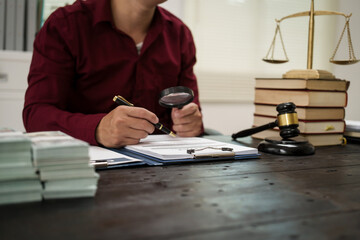 A male lawyer is working at his desk on an online judicial review, focusing on justice, fairness,...