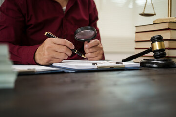 A male lawyer is working at his desk on an online judicial review, focusing on justice, fairness,...