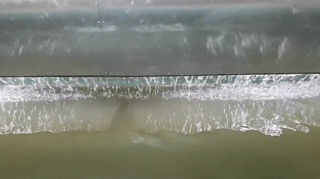 waterfall curtain in front of grey aluminum wall