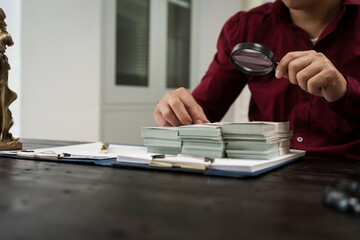 A male lawyer is working at his desk on an online judicial review, focusing on justice, fairness,...