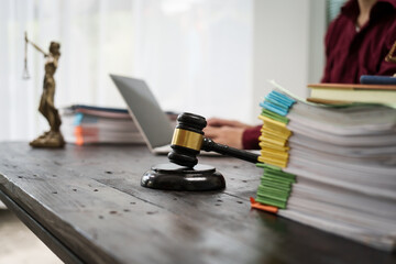 A male lawyer is working at his desk on an online judicial review, focusing on justice, fairness, and legal compliance.He reviews cases, contracts, and legal matters based on general law principles