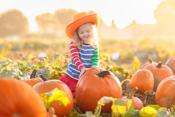 Child playing on pumpkin patch