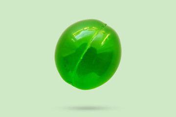 Green soft gel medicine pill capsule isolated on green background