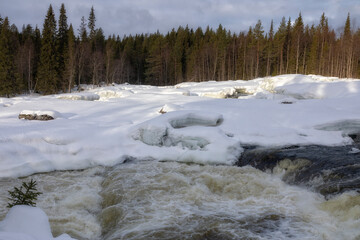 Winter landscape with a waterfall and snow. Russia, Karelia