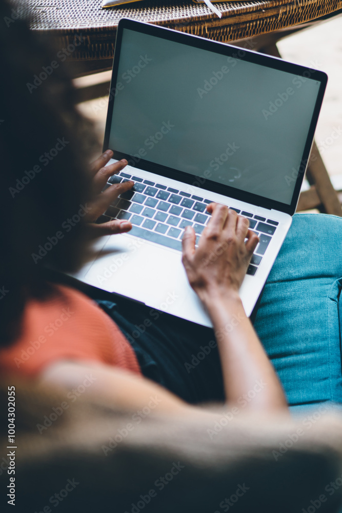 Poster back view of millennial woman copywriter working remotely with content article using 4g wireless int
