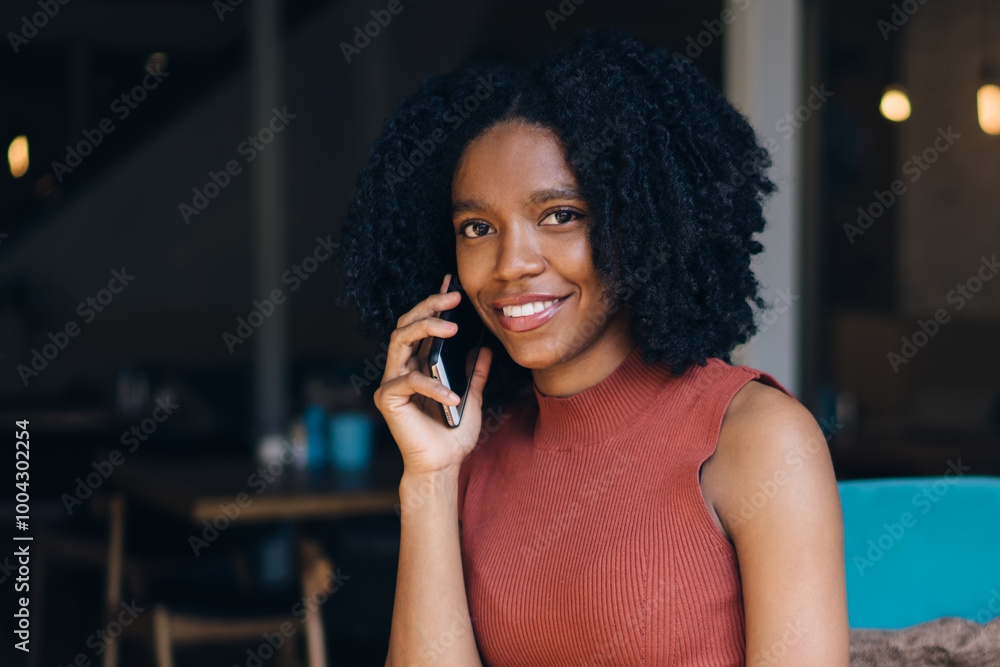 Poster portrait of attractive dark skinned female with caffeine beverage in hand taking rest in cafeteria a