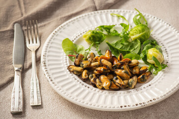 Mussels cooked in coconut oil served with greens and Brussels sprouts