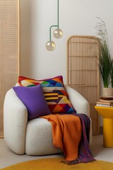  Contemporary interior design featuring a curved sofa, vibrant throw blankets, and geometric pillows, accented by a minimalist hanging lamp. 