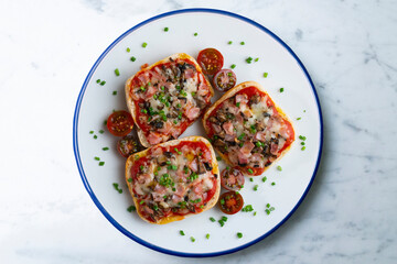 Ham and mini pizzas with mushrooms. Top view table with  decoration.