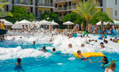Foam party in the pool. The cannon shoots foam.