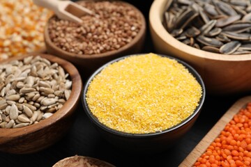 Different types of seeds and cereals in bowls table, closeup