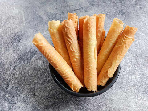 Kue semprong, Asian egg roll, sapit, sepit or kapit. Indonesian traditional wafer snack made by clasping egg batter using an iron mold.