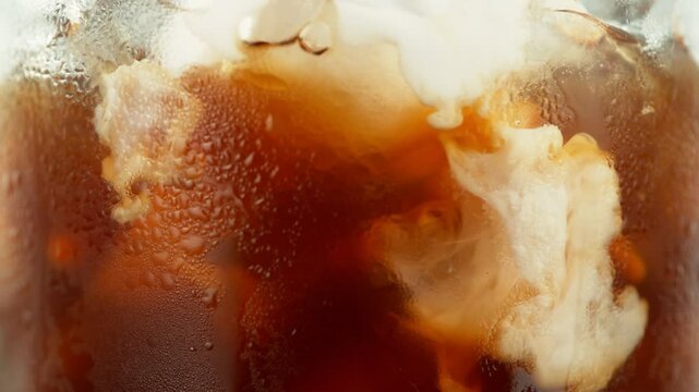 Super Slow Motion of Pouring Milk Into Ice Coffee Drink, Close-up. Filmed on High Speed Cinema Camera, 1000 fps.