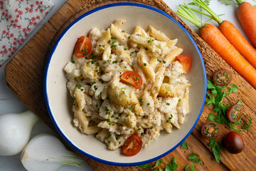 Macaroni and cheese with cauliflower. Top view table with  decoration.