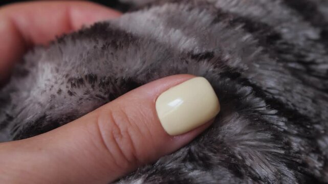 Polyester fabric close up, female hand touching textile.