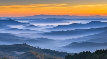 Obraz premium Serene mountain landscape at dawn with layered hills and soft mist.