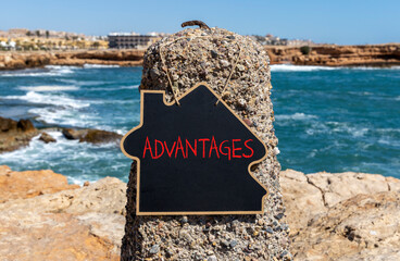 Advantages symbol. Concept word Advantages on beautiful chalk blackboard. Beautiful red stone and...