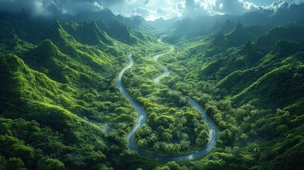 Lush green landscape with a winding road through mountainous terrain.