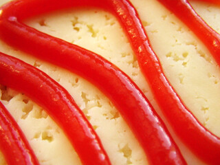 ketchup and cheese on the sandwich 