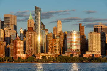 Sunset light on Battery Park and Lower Manhattan skyscrapers in New York City. Cityscape from the...