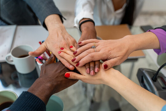 Diverse team unity: hands together in workplace, collaboration and inclusivity concept