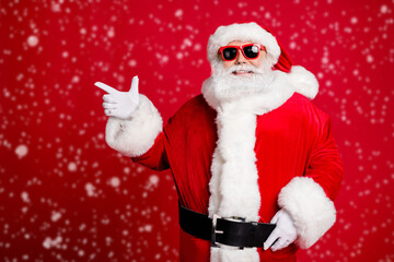 Portrait of his he nice handsome cheerful cheery bearded Santa father showing copy space advice idea like follow subscribe event isolated bright vivid shine vibrant red color background