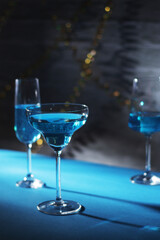 Glasses with blue alcohol cocktail ready for a party