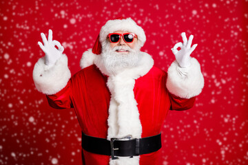 Portrait of his he nice handsome content glad cheerful cheery bearded Santa father showing two double ok-sign celebratory December isolated over bright vivid shine vibrant red color background