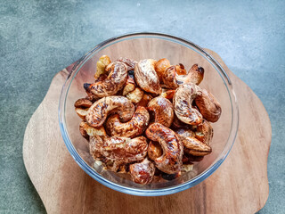 Cashew nuts. Roasted cashew nuts with shell in a bowl. Grilled cashew nuts. Top view.