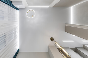 suspended ceiling with halogen spots lamps and drywall construction in empty room in apartment or...