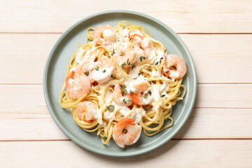 Delicious pasta with shrimps on white wooden table, top view