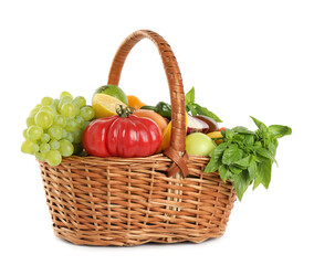 Different fresh fruits and vegetables in wicker basket isolated on white