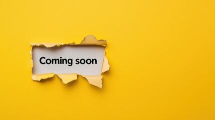 Coming soon is prominently displayed on torn piece of paper against bright yellow background, creating engaging and anticipatory visual