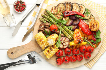 Delicious grilled vegetables served on white wooden table, flat lay