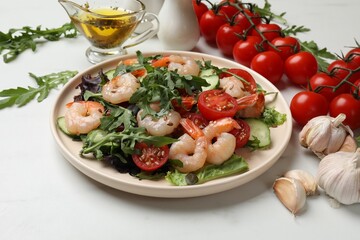 Delicious shrimp salad and ingredients on white marble table