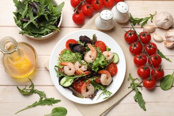 Delicious shrimp salad and ingredients on wooden table, flat lay
