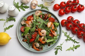 Delicious shrimp salad with ingredients on white tiled table, flat lay