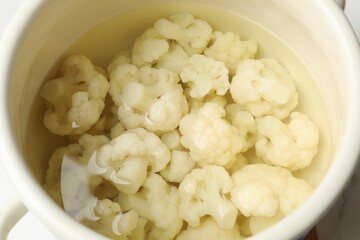 Cauliflower in white pot with water, closeup