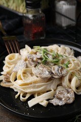 Delicious pasta with mushrooms on table, closeup