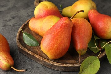 Ripe juicy pears on grey table, closeup