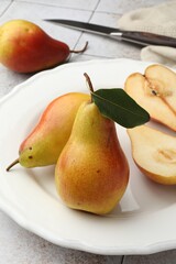 Ripe juicy pears on light tiled table, closeup