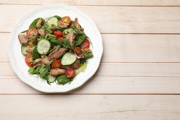 Delicious fresh tuna salad on white wooden table, top view. Space for text
