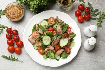 Delicious fresh tuna salad on grey table, flat lay