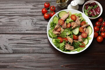 Delicious fresh tuna salad on wooden table, flat lay. Space for text